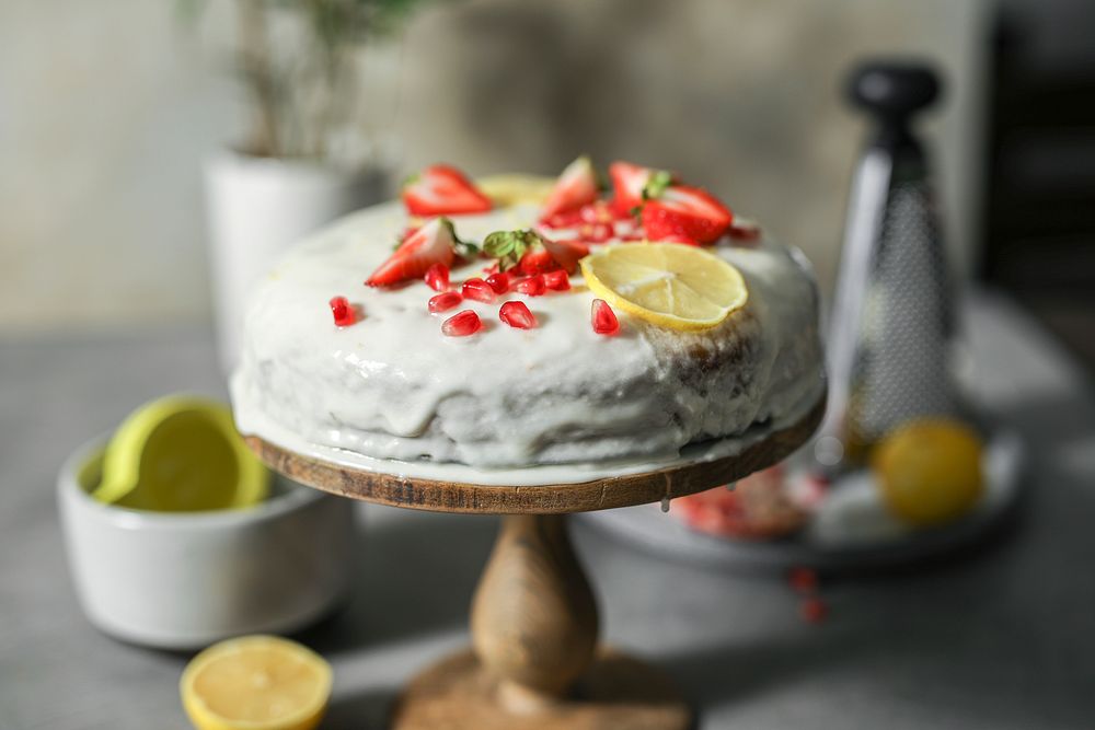 Lemon cake with fresh strawberries and pomegranate seeds