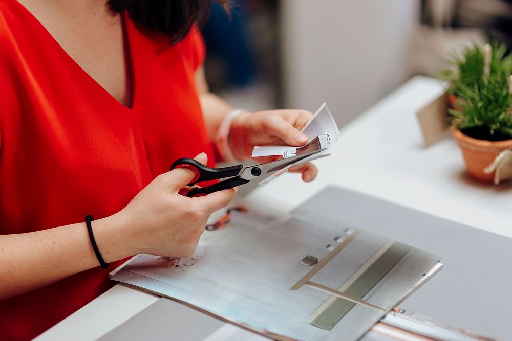 Designer cutting a pattern in a paper