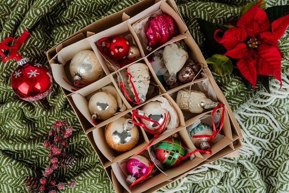 A box of Christmas ornaments on a green cloth