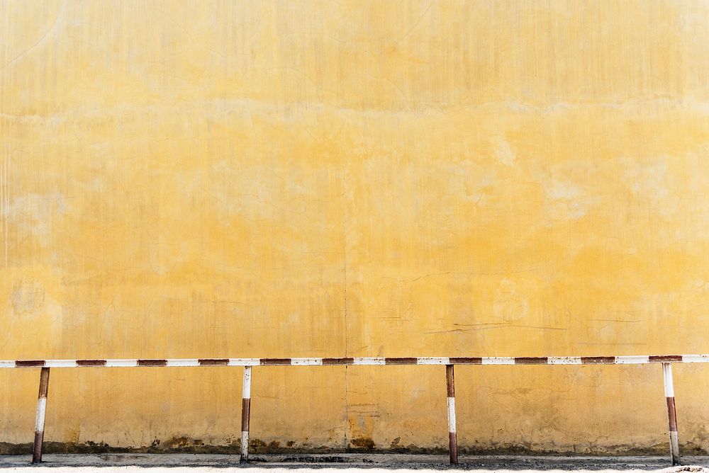 Street safety rails and a yellow wall