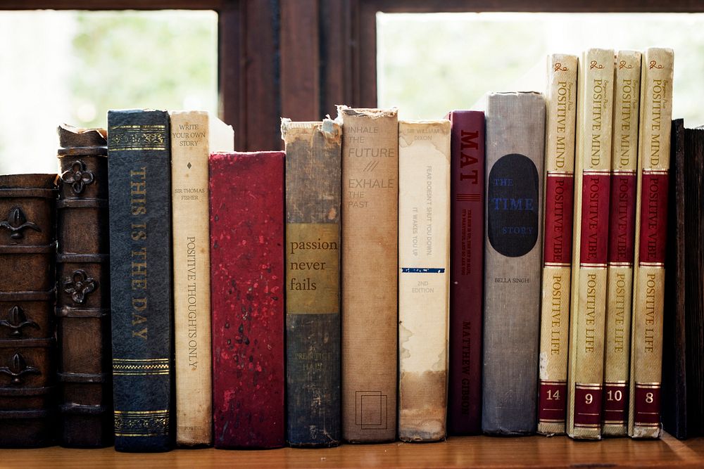 Old books arranged on the shelf