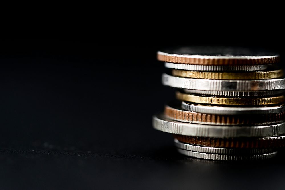 Closeup of coins stack isolated on black background