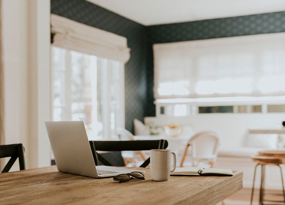 Notebook and a cup of coffee on a wooden table