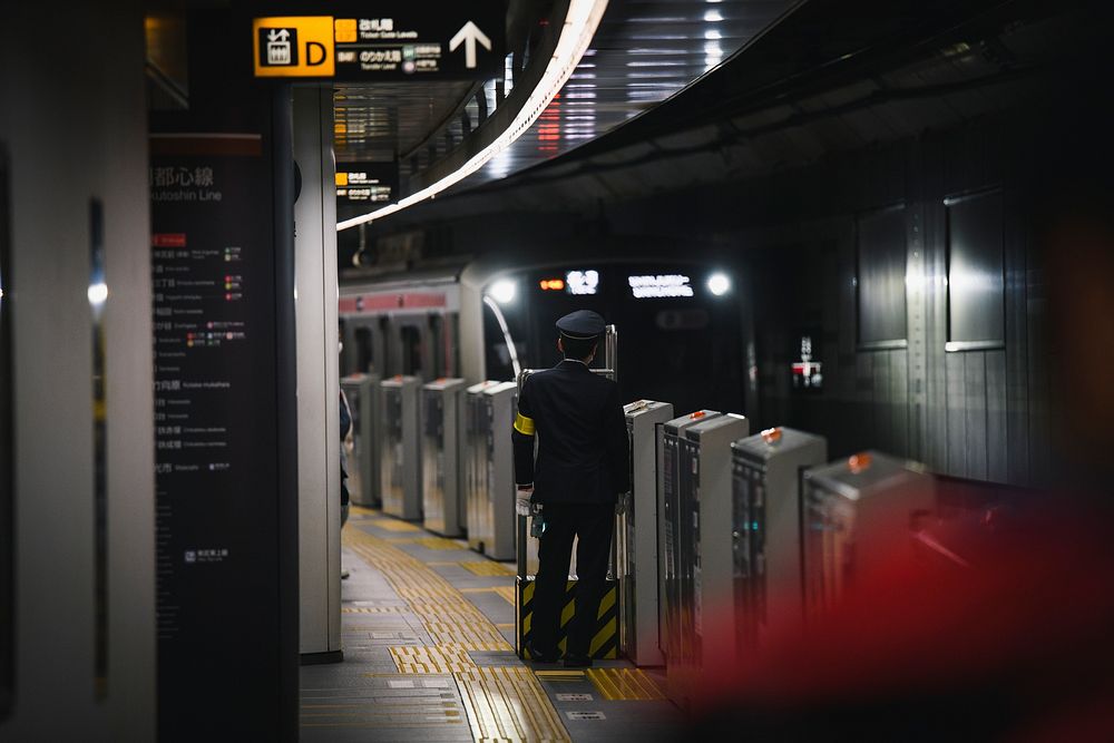 Japanese train conductor at a platform