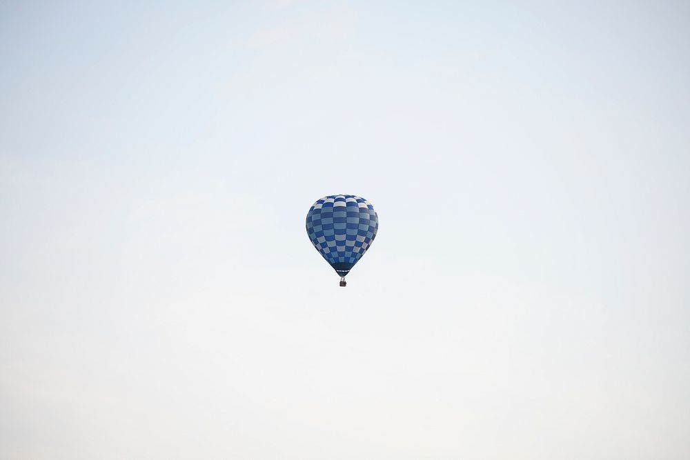 Blue hot air balloon flying in the sky