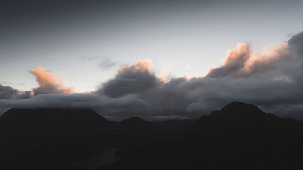 Nature desktop wallpaper background, cloudy sky over a mountain range