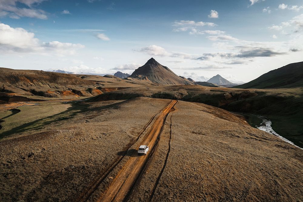 2019, Iceland, White Landrover driving on a dusty sand road