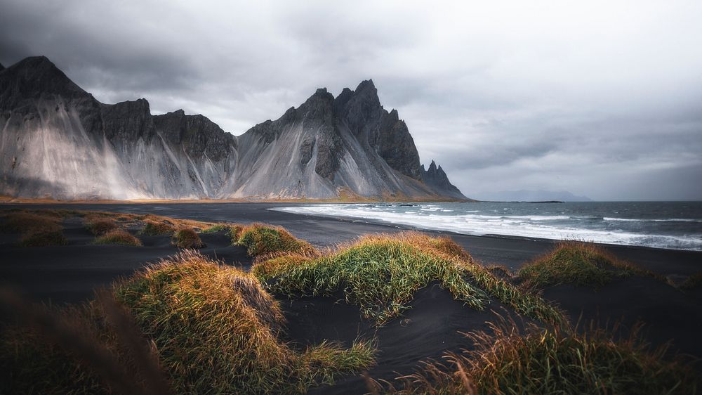 Nature desktop wallpaper background, cloudy black sand beach in Iceland