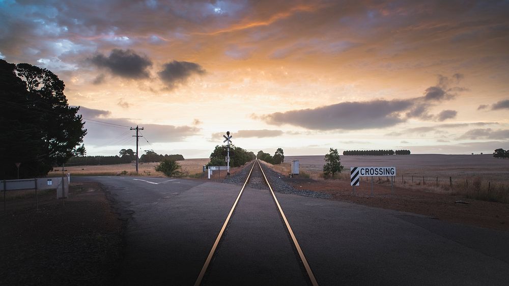 Desktop wallpaper background, railroad in the countryside under a golden sky