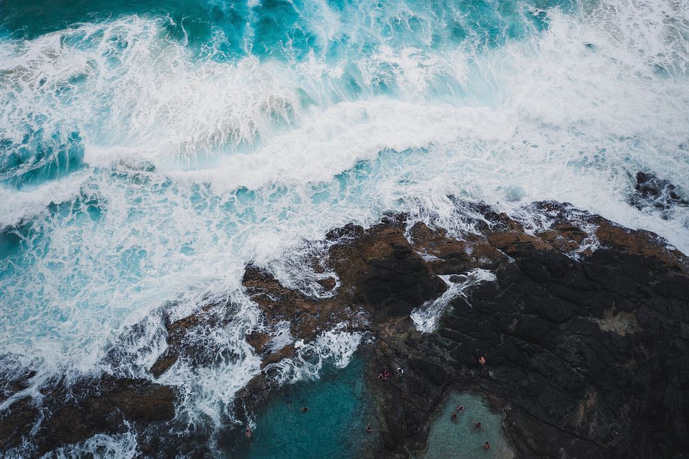 Drone view of sea waves and rocky shore