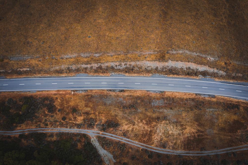 Road to somewhere among a grassland drone view