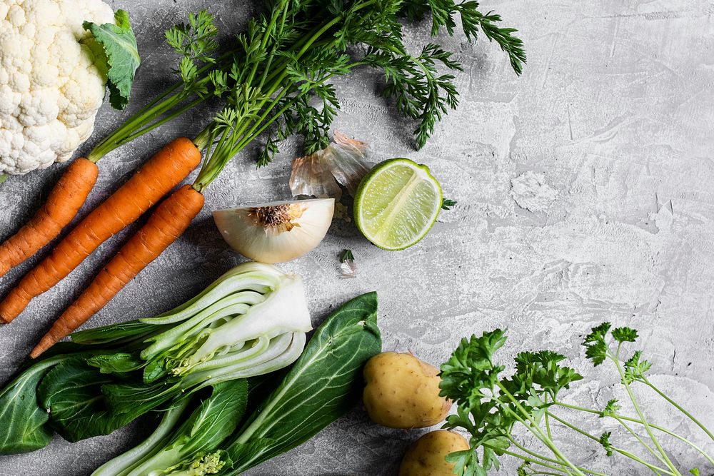 Various fresh organic vegetables on a gray kitchen top