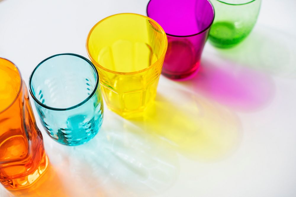Colorful glasses on white background