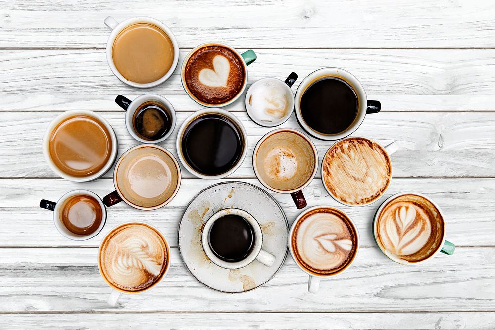 Mixed coffee cups on a white wooden panel 