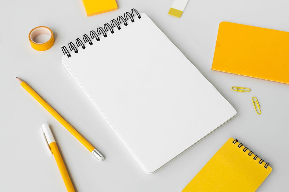 Set of yellow stationery on workspace