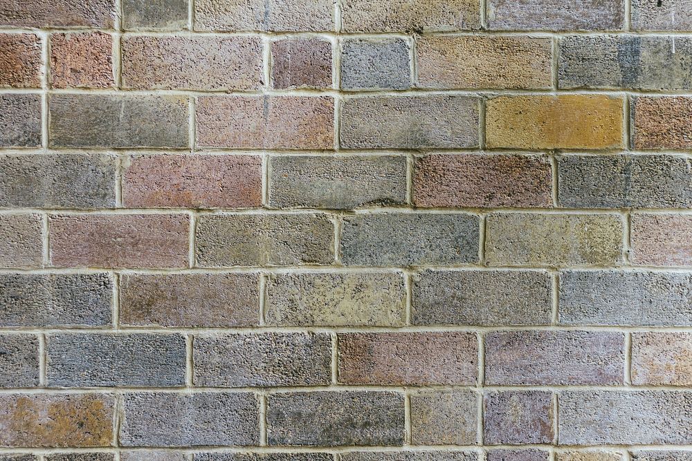 Faded colored brick wall textured wallpaper