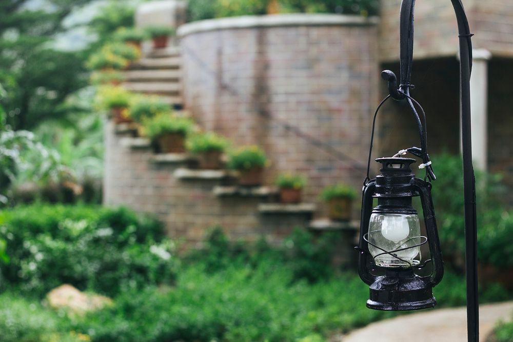 Classic black camping lantern in a garden