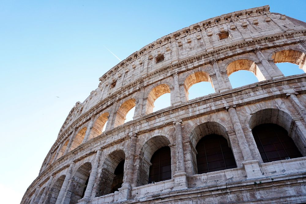Colosseum in Rome under the bright blue sky