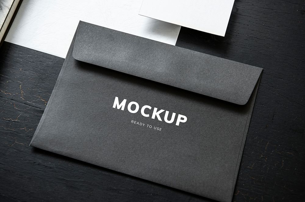 Black envelope mockup on a black table