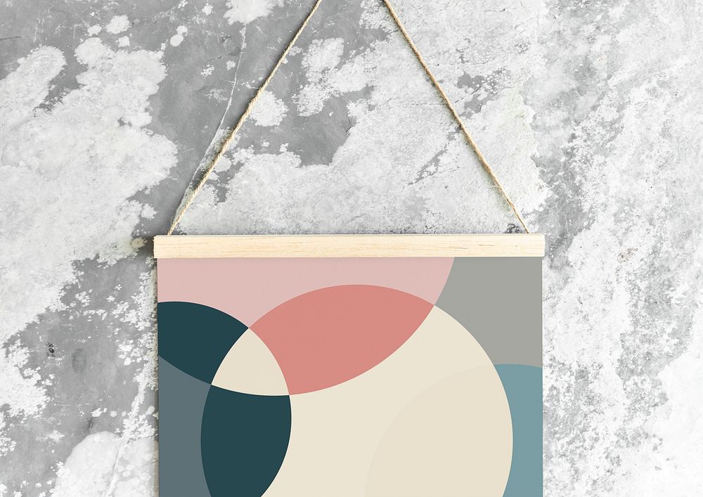 A hanging Swiss design poster on a rustic gray wall