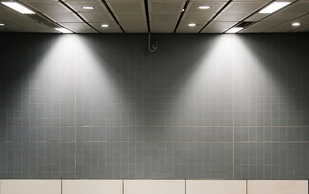 Gray wall mockup inside of a train station