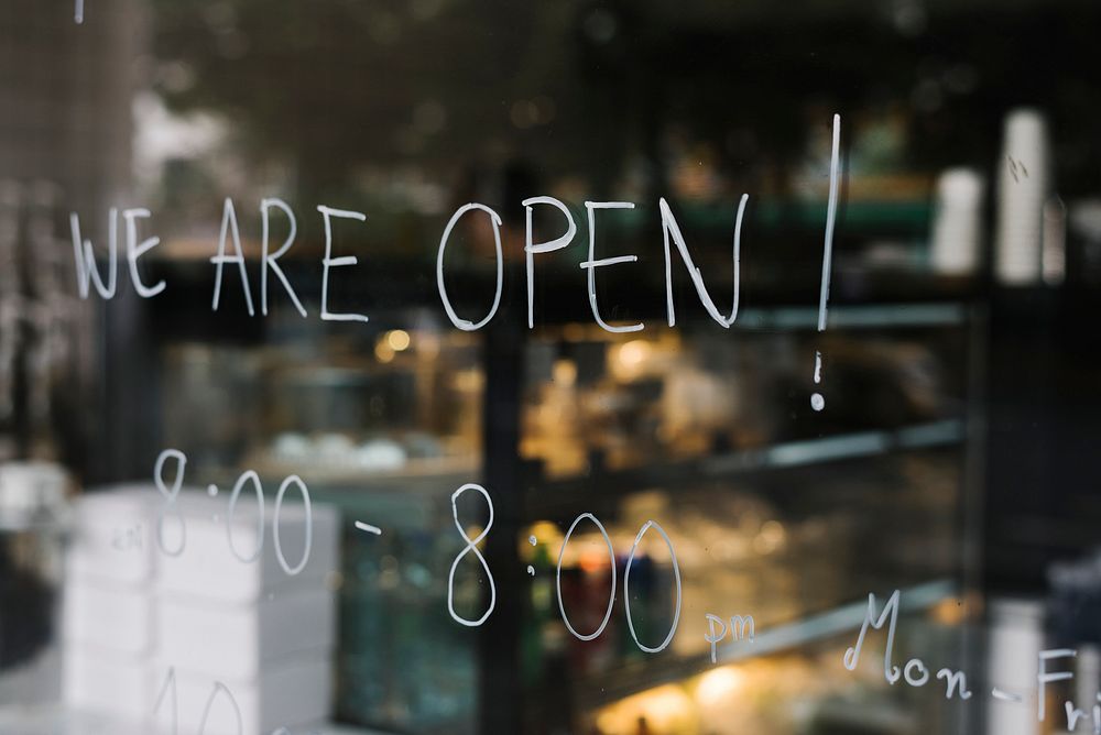 We are open, on a glass wall of a coffee shop