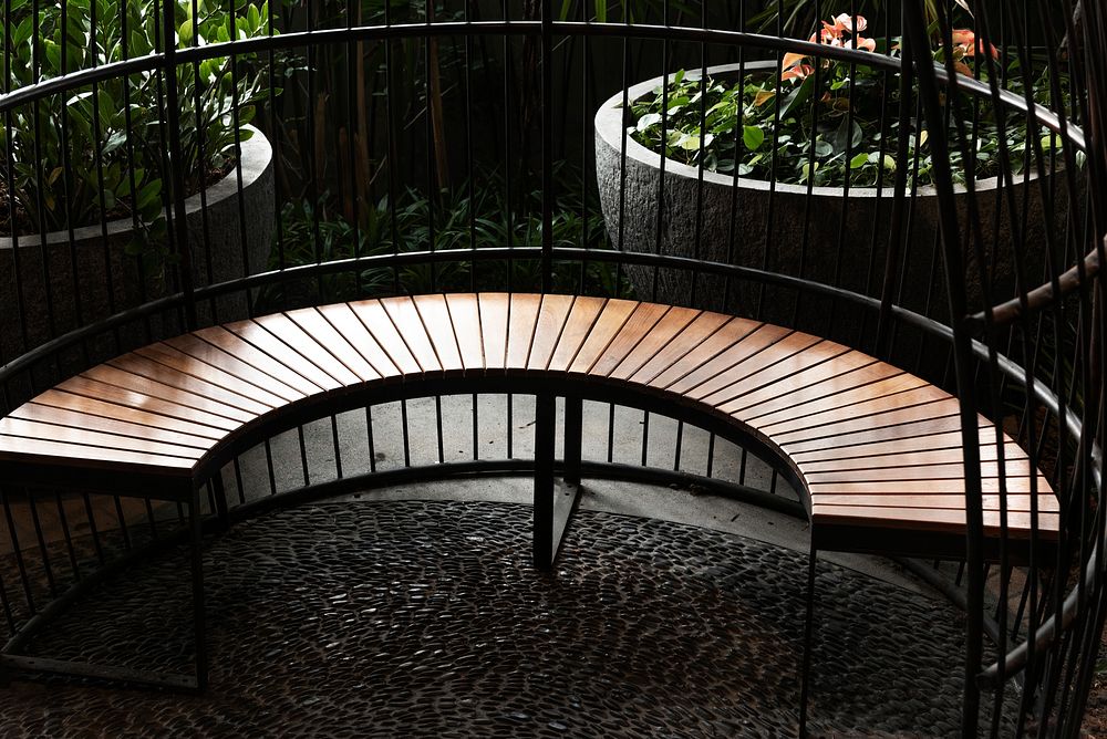 Fenced curved wooden seating in the garden
