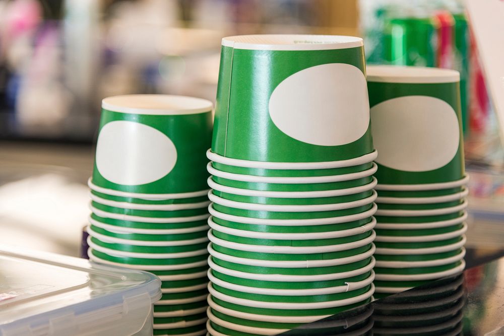 A pile of upside down disposable cup containers