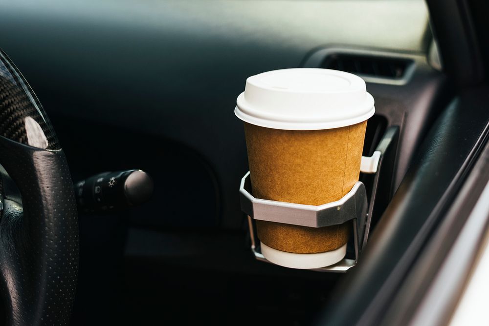 Takeaway coffee cup in a car