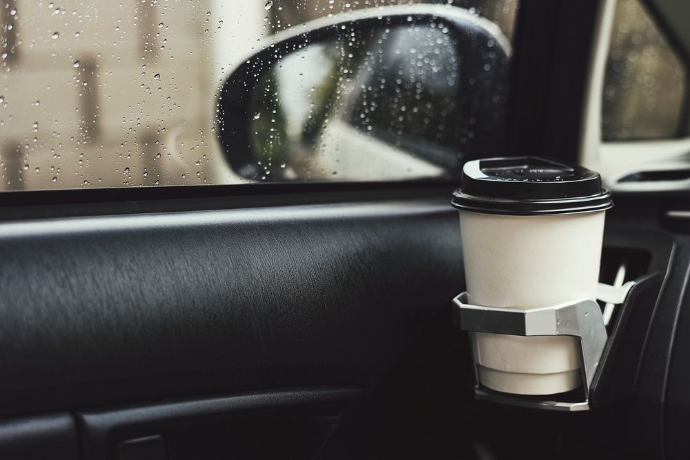 Takeaway coffee cup in a car