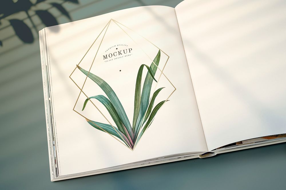 Magazine mockup with leaves and golden frame psd