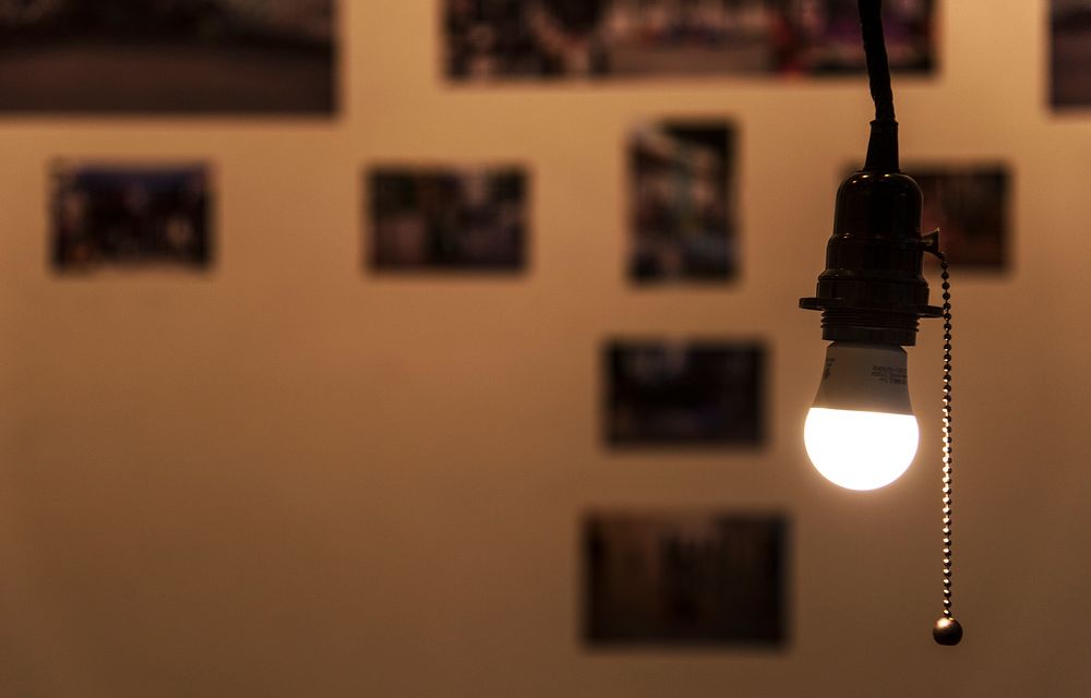 A bright light bulb hanging in a room