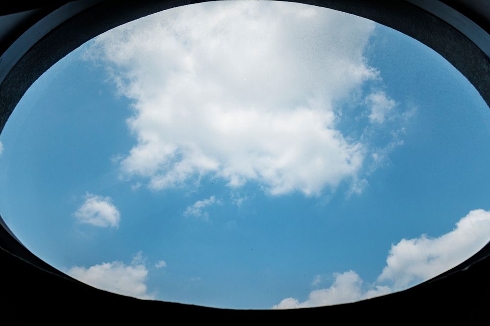 Cloudy blue sky through a window