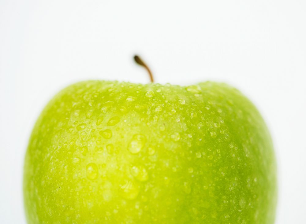Macro shot of green apple isolated on white background
