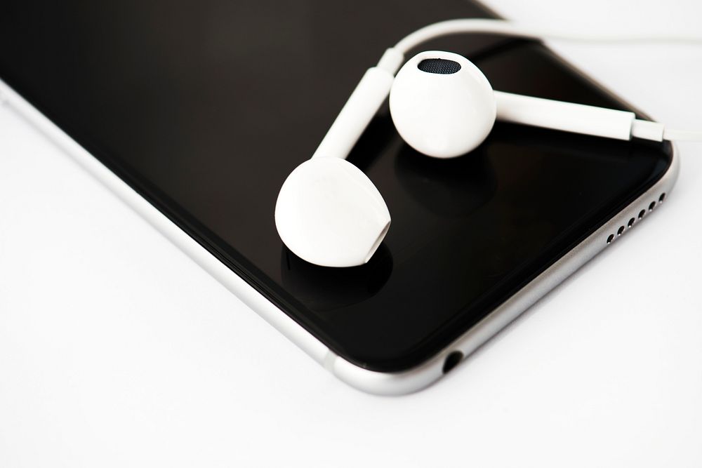 Closeup of mobile phone with earphones