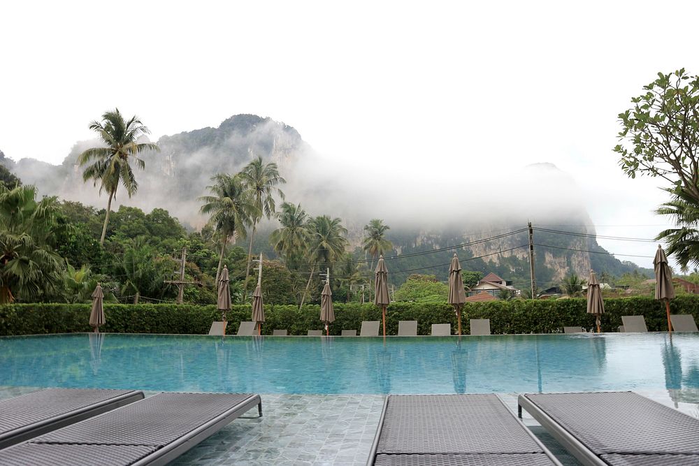 View of a misty mountain from a hotel pool