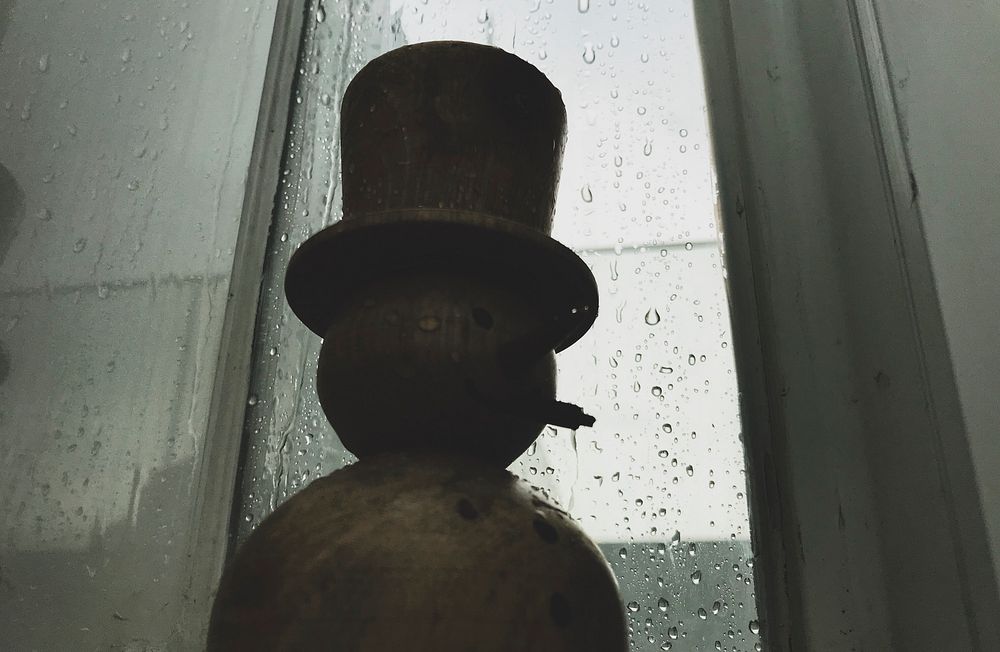 Silhouette of a snowman on a rainy day