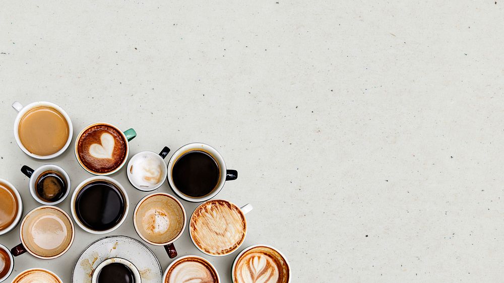 Coffee mugs on a light beige textured wallpaper