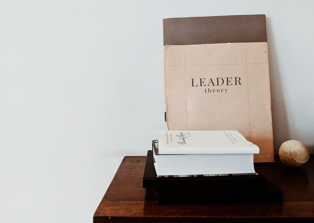 Leader theory book with a baseball on the table