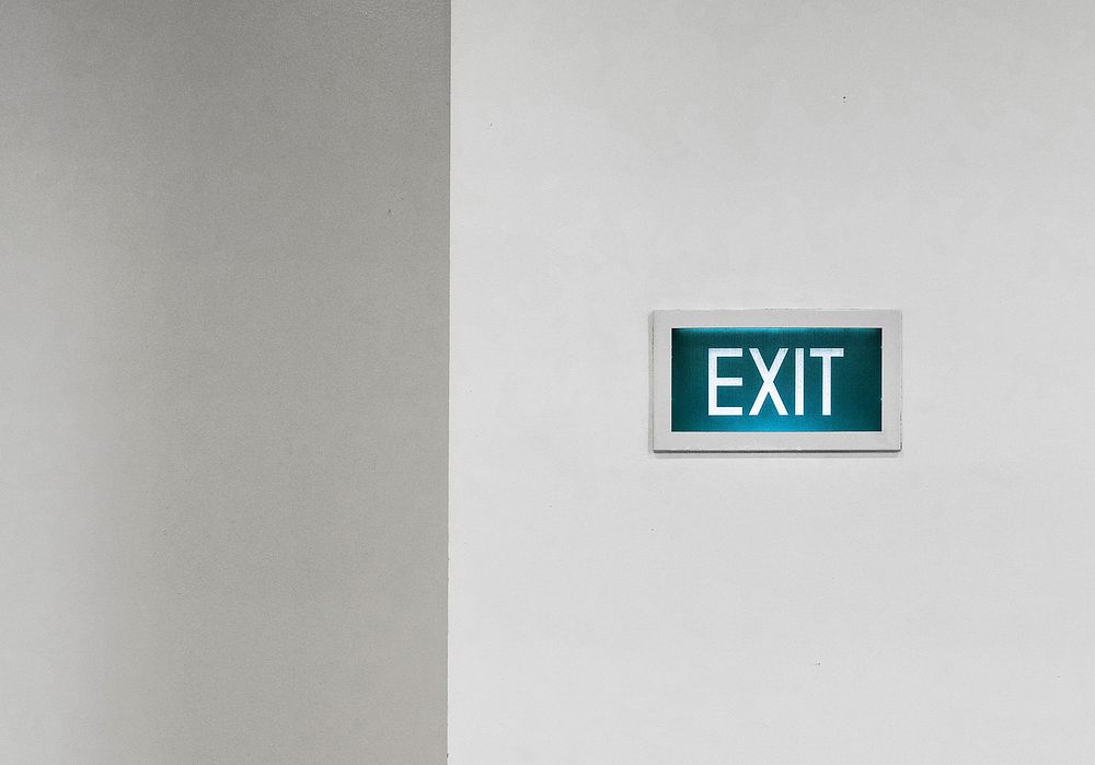 Exit signboard on a white wall