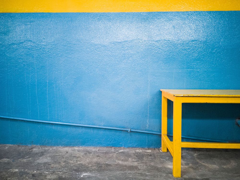 Yellow table against a blue wall