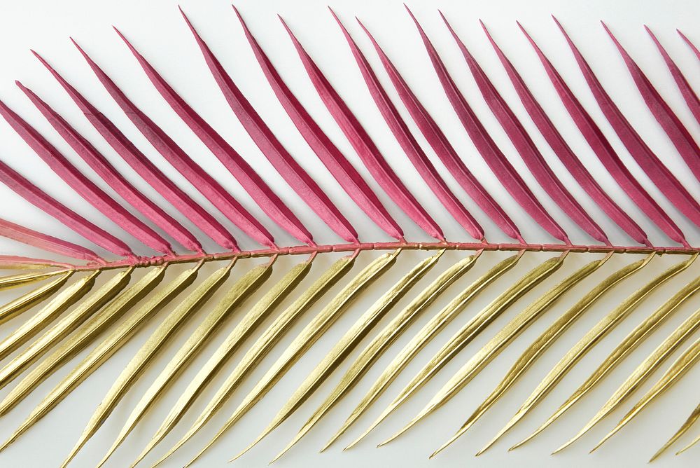 Pink and gold palm leaf background