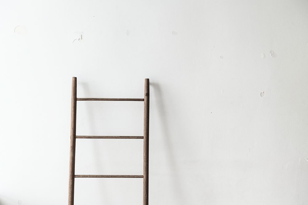 Wooden ladder leaning against a wall