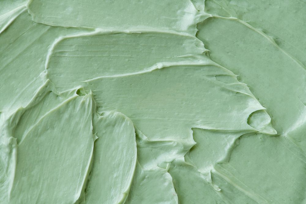 Green frosting texture background close-up