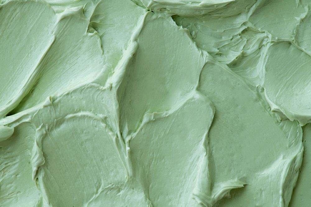 Green frosting texture background close-up