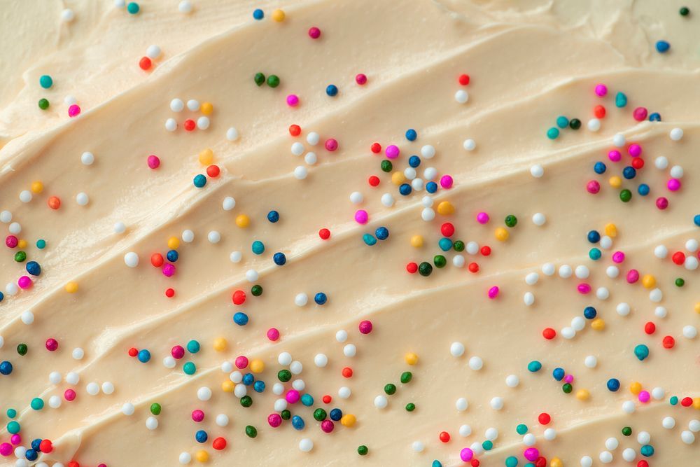 Cake frosting texture background vector with sprinkles on top