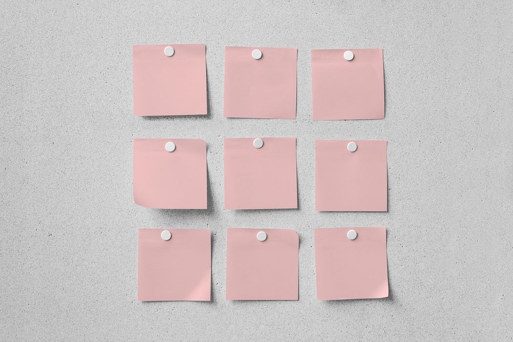 Blank pink note papers, memos on gray wall