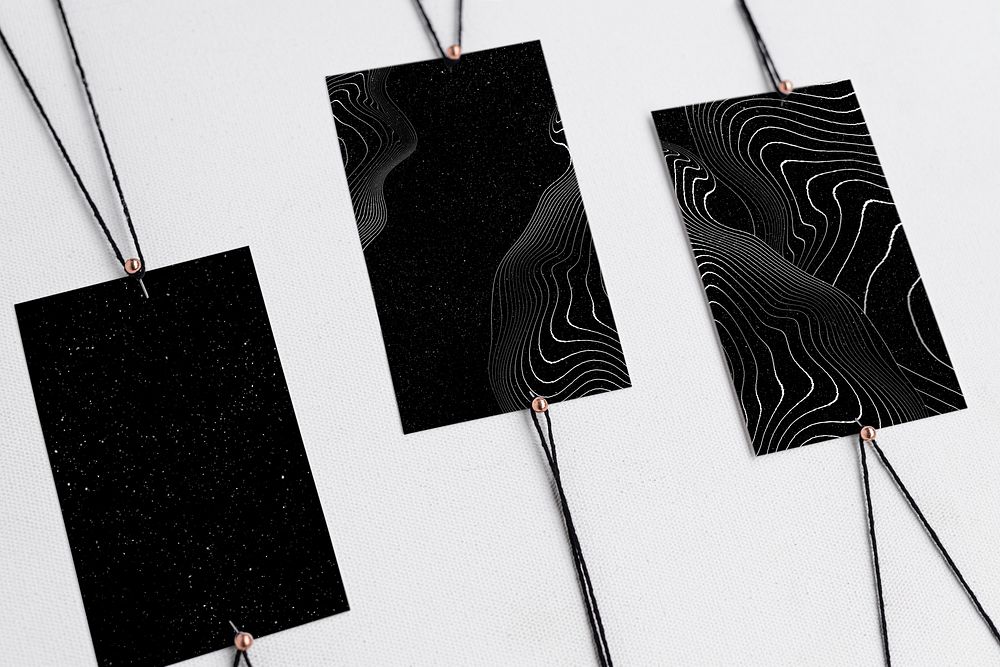 Black label tags with strings, abstract pattern