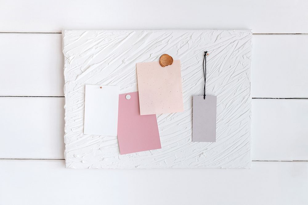 Blank pink papers, label tag pinned on white background