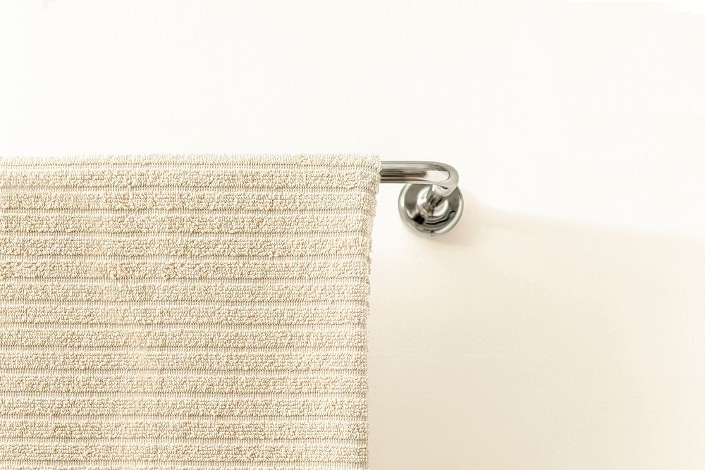 Bath towel mockup psd, hanging on a rack, home decor